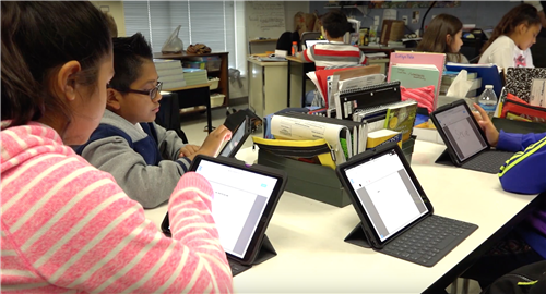 students using iPads with keyboards 